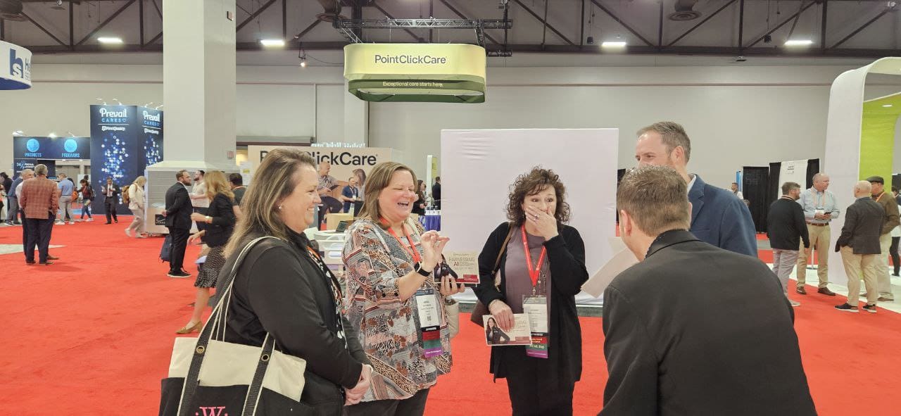 David Farr performing close-up magic for attendees at a trade show booth during a corporate convention