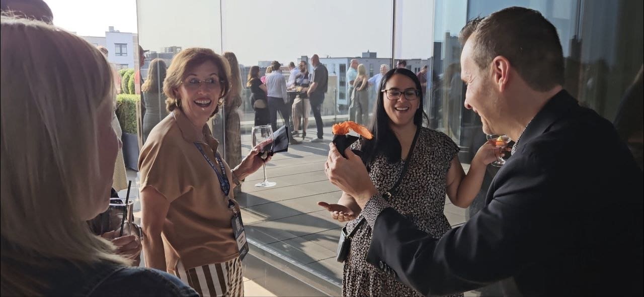 David Farr performing close-up magic for guests at a corporate rooftop reception in Minneapolis
